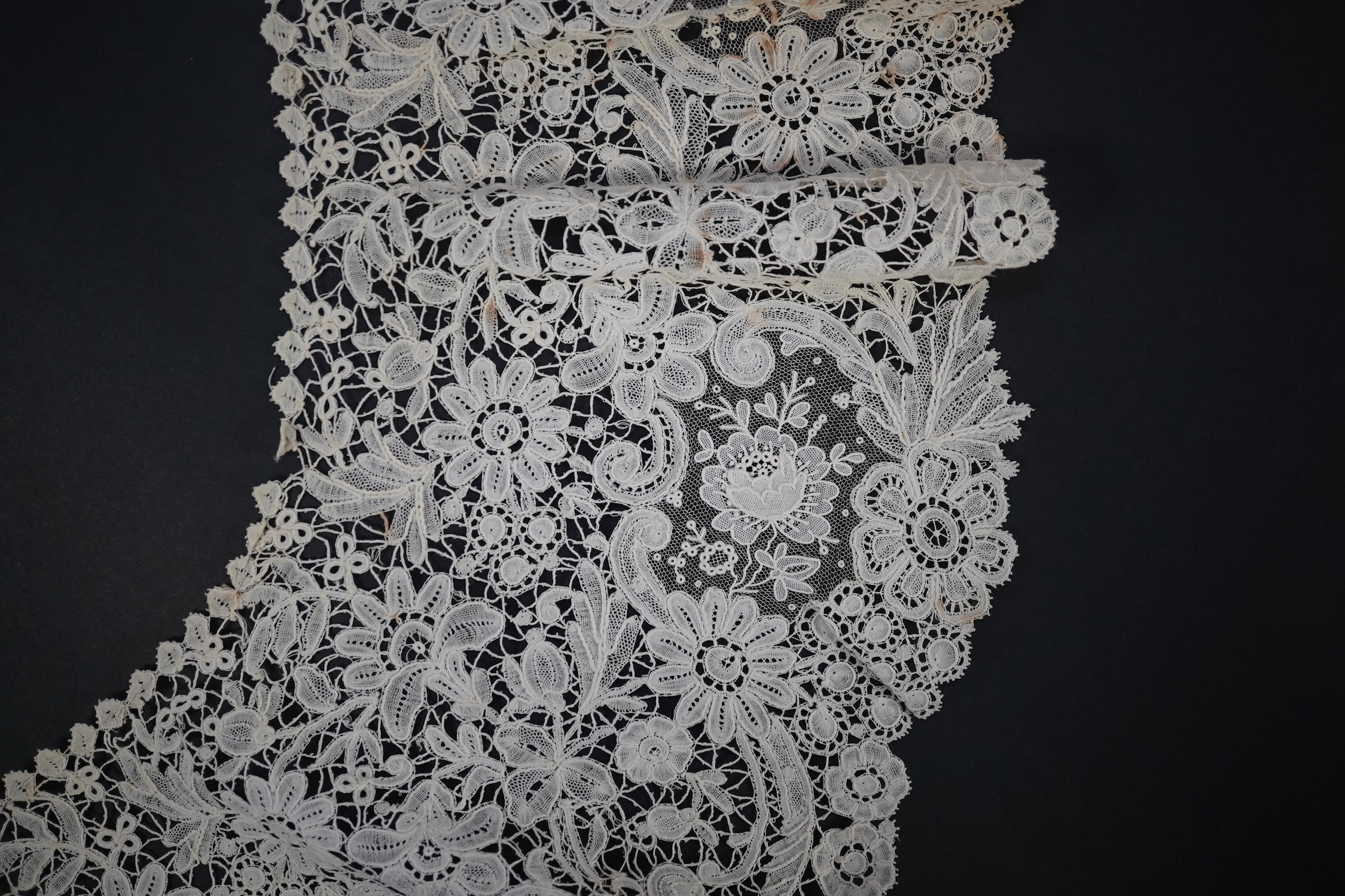 An 1860’s unused, large circular flounce shaped collar of mixed Brussels bobbin lace, with twelve needle lace Point de Gaz insertions, 18.5cm deep, approximately 248cm along bottom, edge. Condition - good